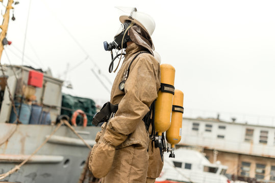 Firefighter on a ship in undeveloped countries with old equipment on a training how to stop fire in a dangerous mission and protect the environment