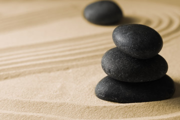 Fototapeta na wymiar Stacked zen garden stones on sand with pattern, space for text. Meditation and harmony