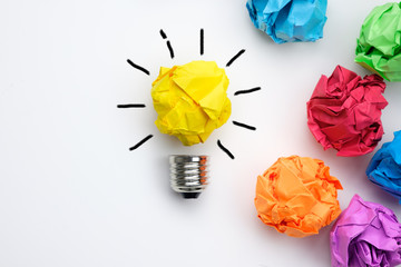 Great idea concept with crumpled colorful paper and light bulb on white background - Powered by Adobe