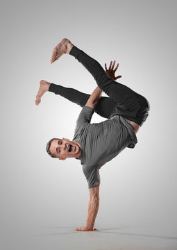 Hip hop guy performs breakdance acrobatic elements. Man dancing