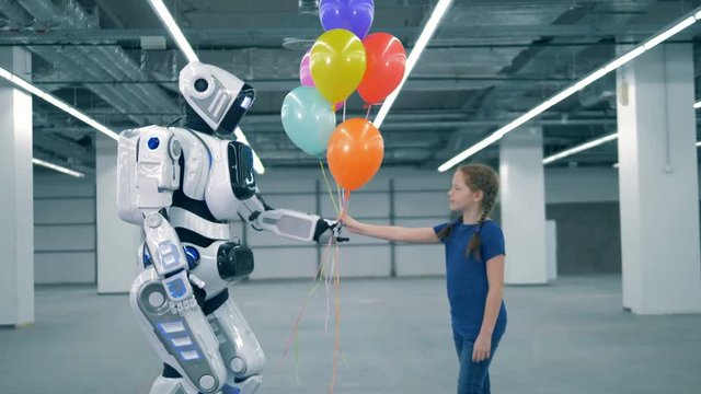 Massive cyborg is giving balloons to a girl and touching her hand