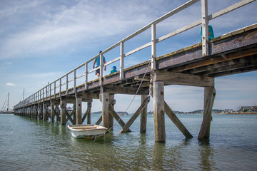 pier over the ocean with boat