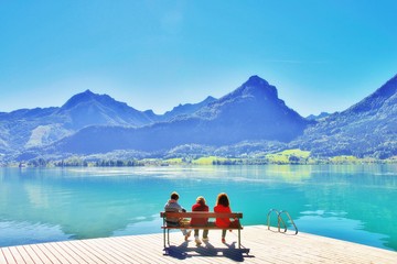Three mature ladies enjoying a nice day outside. Beautiful view at mountains, senior woman with hat...