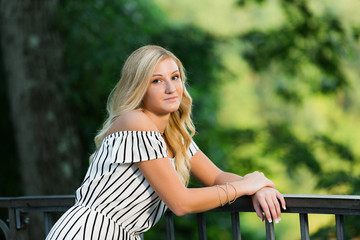 High School Senior Photo of Blonde Caucasian Girl Outdoors in Romper Dress