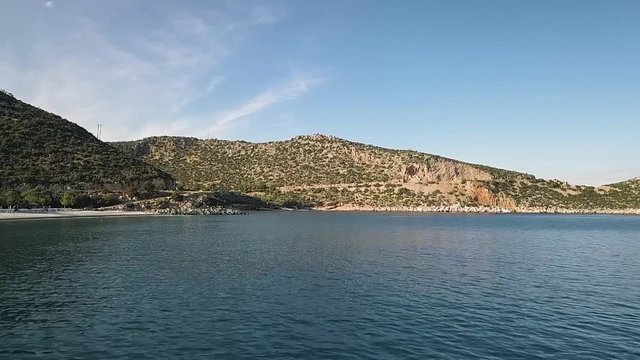 Flying in low altitude over the sea at first and then higher while on the left there is a part of the eastern region of the Peloponnese coastline, in Greece