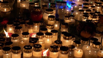 Bright lights of burning candles in the darkness 