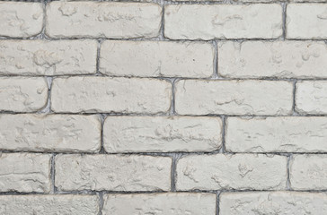 Beautiful background of a white brick wall. Textured structure. Decorative abstract design. Image of a beautiful brickwork.
