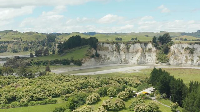 Aerial pan over beautiful white clay Rangitikei cliffs and river, New Zealand. 4k
