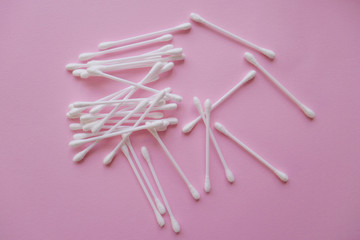 Plastic cotton buds on a pink background, Flat lay, view from above