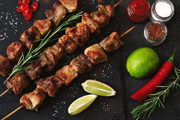 Appetizing skewers on a stone board with rosemary and seasonings. Keto diet. Keto lunch