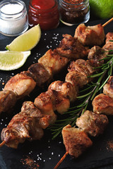 Appetizing skewers on a stone board with rosemary and seasonings. Keto diet. Keto lunch