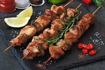 Appetizing skewers on a stone board with rosemary and seasonings. Keto diet. Keto lunch