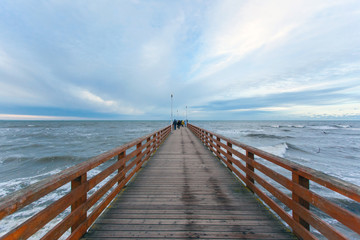 wooden pier extending into the distance by the sea