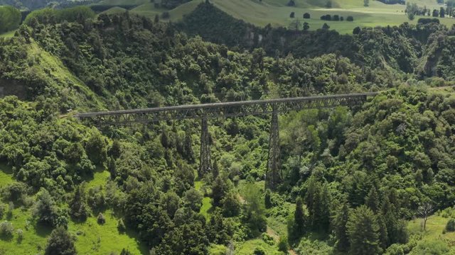 Aerial pull back from Rangitikei railway bridge in midland New Zealand. 4k