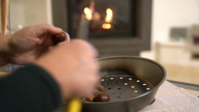 4K clip, a man slices chestnuts