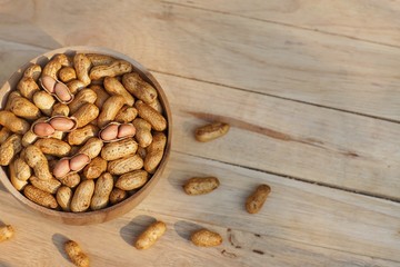Roasted peanut, snack, in wooden bowl with classic wood background