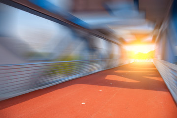 Rubber track under modern steel bridge