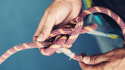 Rope with Climbing eight knot in man hands - Powered by Adobe