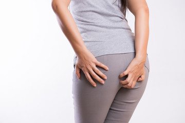 Woman suffering from hemorrhoids and hand holding her bottom because having Abdominal pain. Health care concept.