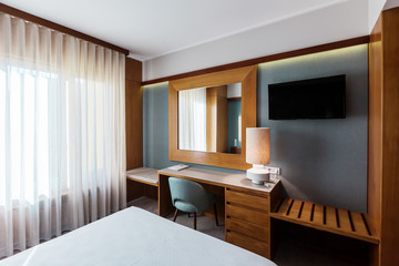 Small Hotel room interior with blue colours wall, wooden elements in design