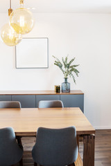 Living room interior details, table, lamps, frame on white wall