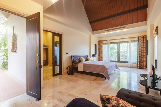 Modern bed room interior in Luxury villa. Big window, open door, marble floor