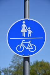 bicycle ,mother and child, blue traffic indicator in germany