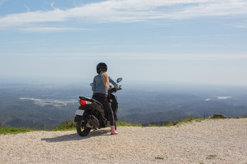 Woman with long white hair dreads travel by scooter in european mountains