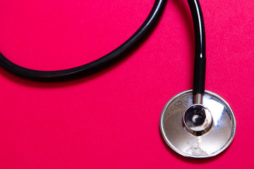 Stethoscope on pink background
