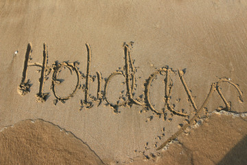 holiday word on sand 