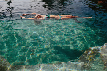 Woman in swimming pool outdoor. Summer sunny  day