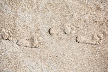 Fototapeta na wymiar Inside out steps on sea shore sand