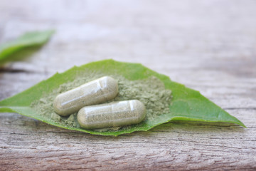 herbal medicine in capsules for healthy eating with herb leaf, alternative supplement for good living lifestyle 
