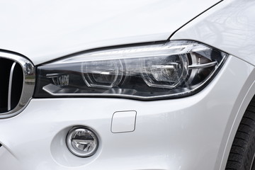 shiny headlight on a  white car