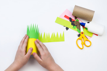 Child does the handicraft. Fruit paper. Pineapple and Watermelon summer.