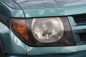 shiny headlight on a  white car