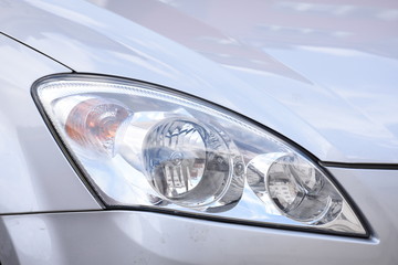 shiny headlight on a  white car
