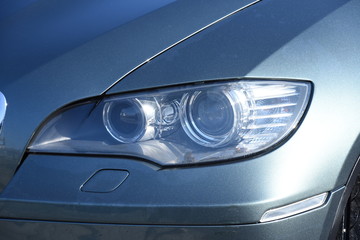 Obraz na płótnie Canvas Car's exterior details. shiny headlights on a new car
