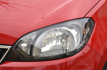  Car's exterior details. shiny headlights on a red car