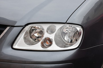  Car's exterior details. shiny headlights on a  gray car