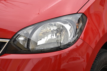 shiny headlights on a red  car