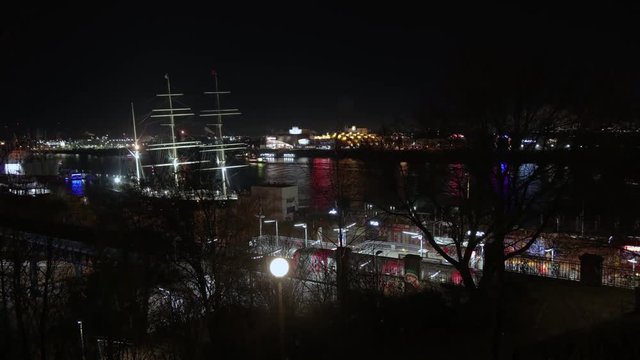 Time lapse long exposure from the rickmer rickmers in hamburg harbor by night. you see ships  and subway passing by