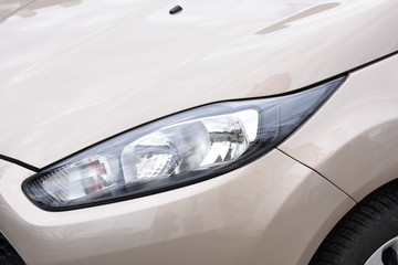 Obraz na płótnie Canvas Car's exterior detail, headlight on a new car
