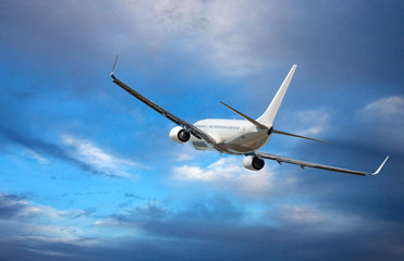 Fototapeta na wymiar Aircraft is flying in blue cloudy sky