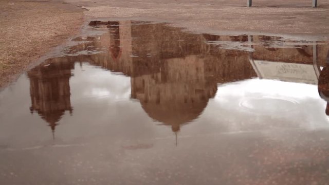 This is a shot of the Mission San Jose in San Antonio, TX. 
The Mission San Jose is being reflected in a puddle of water after a rainstorm.