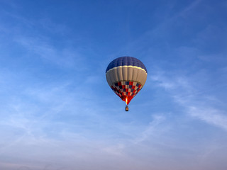 Hot air balloon behind blue sky