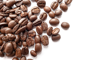 Roasted coffee beans isolated on white background. Close-up.