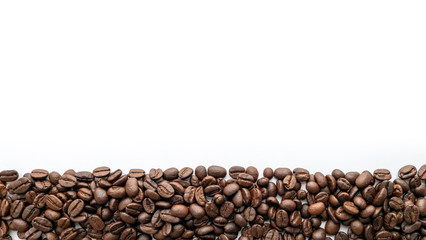 Roasted coffee beans on white background. Close-up.