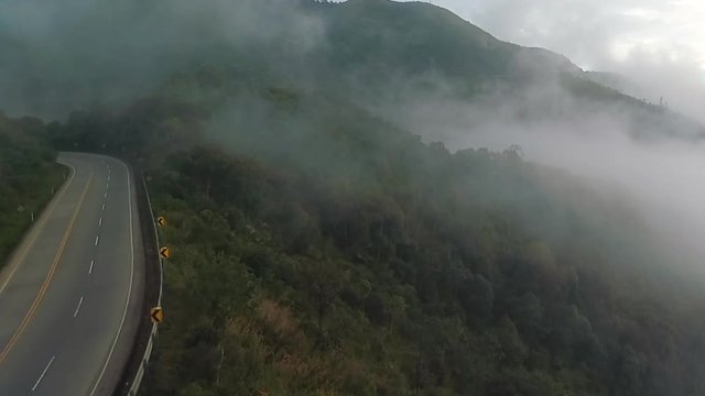 Aerial video showing vehicles on a foggy day along the Cuenca-Guayaquil-Naranjal highway near Molleturo.