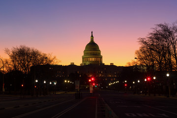 A view on US Capitol from Pennsylvania avenue at dawn in Washington DC, USA. Beautiful winter sunrise with clear skies.